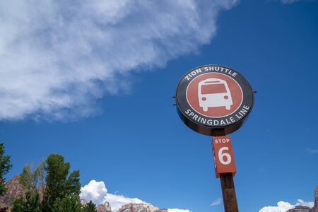JULY  17 2018 - SPRINGDALE, UTAH: Artistic angle of the Zion National Park shuttle bus stop sign. The shuttle bus is mandatory during the busy summer months for National Park visitors and touristsのeditorial素材
