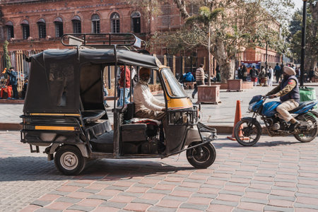 Amritsar, India - Febuary 8, 2020: Tuk tuk driver (or auto rickshaw) in the town square of Amritsar...