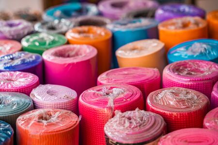 Selective focus on colorful new yoga mats for sale at a market in Rishikesh, India the birthplace of yogaの写真素材