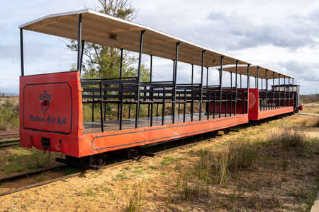 Tavira, Portugal - January 23, 2020: The red mini train at Pedras del Rei station departing for Barril beach at Ilha de Tavira lets visitors forgo the 1km walk to Anchor Cemetaryのeditorial素材