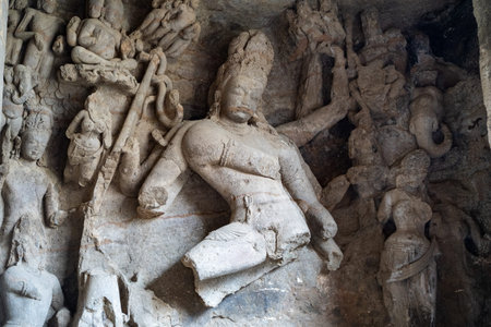 Ancient Shiva statue carved out of stone inside a cave at Elephanta Caves ruins in Mumbai (Bombay)...
