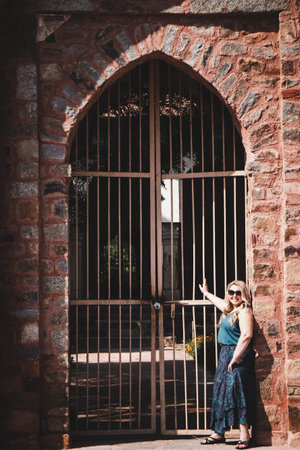 Blond tourist poses at the gate of Tomb of Sikandar Lodi, a ruler of the Lodi Dynasty in Lodi...