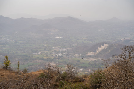 Very hazy, polluted aerial cityscape view from the Monsoon Palace of Udaipur, India