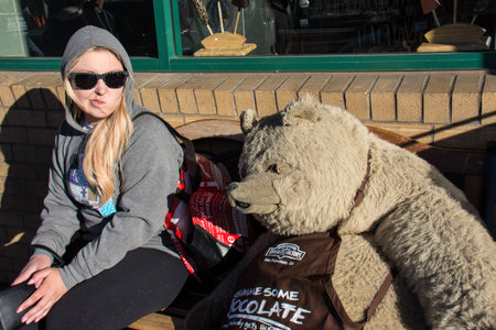 JULY 7 2017 - SAN FRANCISCO, CALIFORNIA: An adult female tourist looks in disgust at a Rocky Mountain Chocolate bear mascot, "Truffles", outside of the Fisherman's Wharf candy store.のeditorial素材