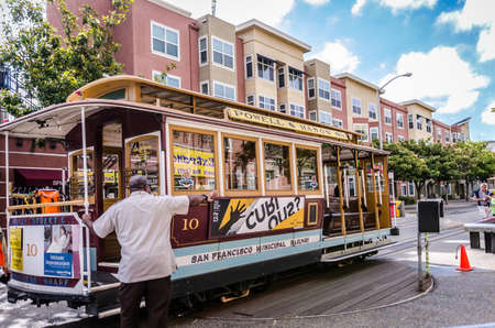 MAY 30 2016 - SAN FRANCISCO, CALIFORNIA: A worker turns around the Hyde and Powell cable car near Fisherman's Wharf, on a spring day. This cable car station is popular with tourists.のeditorial素材