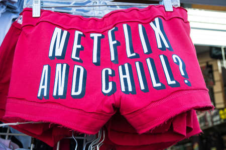 JULY 7 2017 - SAN FRANCISCO, CALIFORNIA: Shorts sold at a gift shop with the slang phrase "Netflix and Chill" printed on the buttのeditorial素材