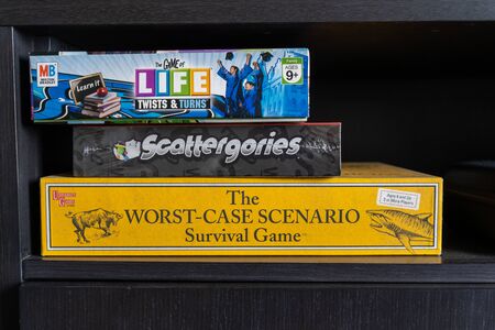 Variety of board games on a shelf in a homeの写真素材