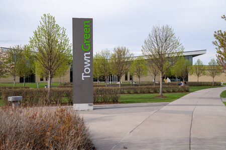 Maple Grove, Minnesota - May 14, 2020: Sign for the Town Green of Maple Grove, a public park and community gathering space in the suburban townの写真素材