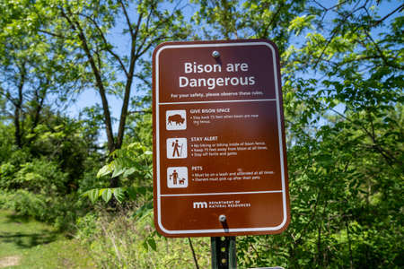 Mankato, Minnesota - June 5, 2020: Sign warning hikers about dangerous bison wildlife, with a list of rules to follow for safety at Minneopa State Parkのeditorial素材