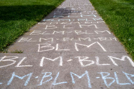 Black Lives Matter (BLM) written in chalk on a sidewalk in Maple Grove, Minnesota after the death of George Floyd and resulting protests for changeのeditorial素材