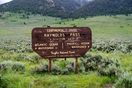 Continental Divide - Raynolds Pass sign in the Targhee National Forest on the Idaho and Montana border along Highway 87のeditorial素材