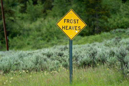Sign warning drivers of frost heaves in the roadの写真素材