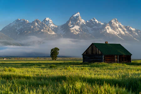 Rustic building, part of the historic Morman Row homestead in Antelope Flats, in Grand Teton National Park Wyoming, at sunriseの写真素材