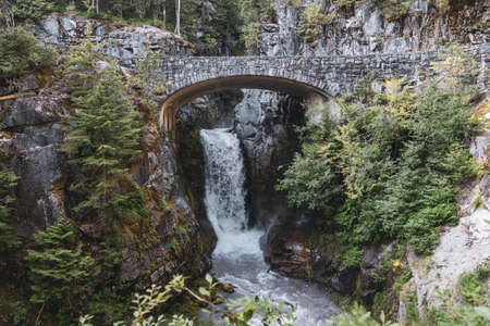 Christine Falls in Mt Rainier National Park is a waterfall with a picturesque bridgeの写真素材