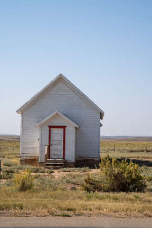 Old, abandoned whitewashed small building, taken in rural Wyoming, near Carterの写真素材