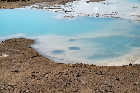 Beautiful milky teal water in a hot spring along the porcelain basin trail, in Yellowstone National...