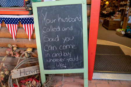 Chalkboard sign in front of a store reading Your Husband called and said you can come in and buy...