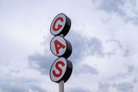 Generic gas station sign against a cloudy skyの写真素材