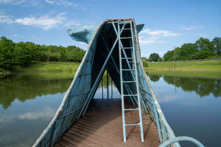 Catoosa, Oklahoma - May 5, 2021: The famous road side attraction Blue Whale of Catoosa along historic Route 66. View of the old ladder from the waterslideのeditorial素材