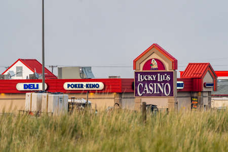Anaconda, Montana - July 11, 2021: A Lucky Lils Casino sign at a Towne Pump Gas Station, taken at dusk and sunsetのeditorial素材