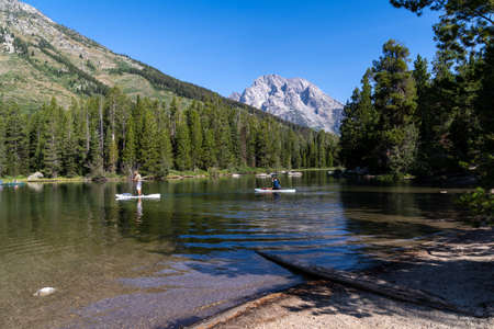 Wyoming, USA - August 9, 2021: Kayakers and paddleboarders boating on String Lake, in Grand Teton National Parkのeditorial素材