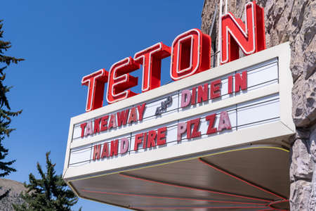 Jackson, Wyoming - August 9, 2021: Old fashioned neon sign for the Teton movie theater, now a pizzaria restaurantのeditorial素材