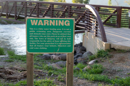 Warning sign informing visitors to the river of a no swimming area, this is a white water rafting boarding areaの写真素材