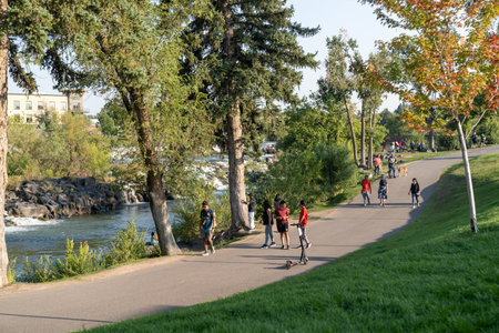 Idaho Falls, Idaho - August 22, 2021: People out enjoying the walking paths and trails near the waterfall and damのeditorial素材
