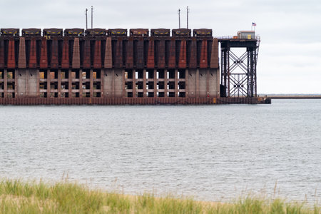 Working ore dock in Marquette Michigan, as seen from a nearby beachのeditorial素材