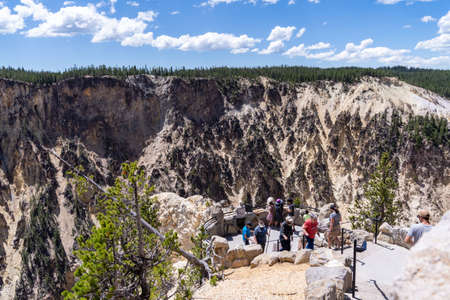 Wyoming, USA - June 29, 2021: Tourists enjoy the view from Inspiration Point in Yellowstone National Park, in the canyon area, looking down at the riverのeditorial素材