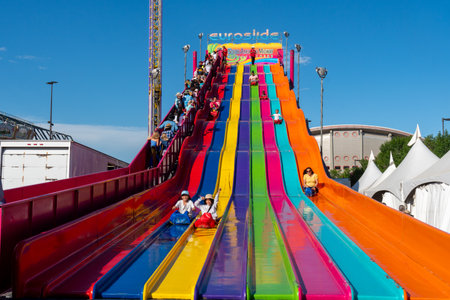 Calgary, Alberta, Canada - July 16, 2022: Riders enjoy using the giant slide, known as the Euroslide at the midway at the Calgary Stampedeのeditorial素材