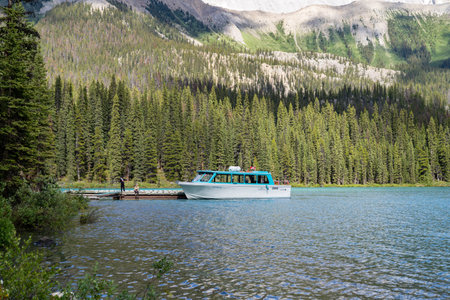 Jasper, Alberta, Canada - July 13, 2022: The Maligne Lake boat cruise vessel waits for passengers to board while docked on Spirit Islandのeditorial素材