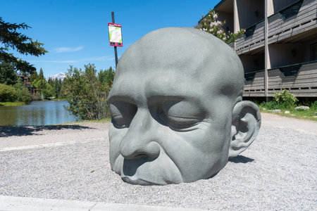 Canmore, Alberta - July 14, 2022: The The Caen More Big Head Sculpture, is a famous landmark in the downtown areaのeditorial素材