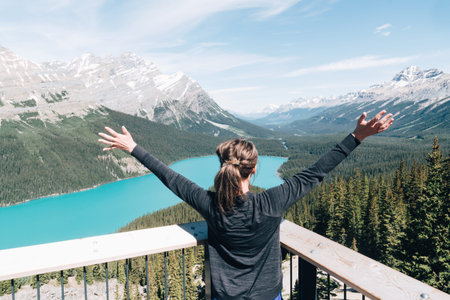 Woman with arms outstretched views Peyto Lake in Banff National Parkの写真素材