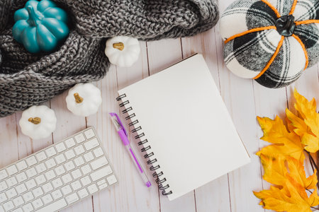Fall journal or diary flat lay, with notebook, pen, computer keyboard, maple leaves, and pumpkins. For bloggers, work from home conceptsの写真素材