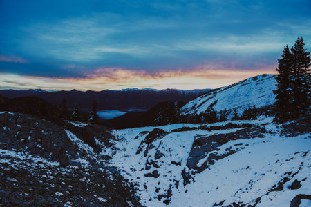 Snow on the mountains in Wyoming, near Alpine, WY, during a fall snowfall at sunrise