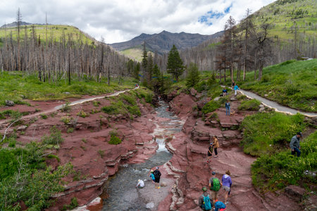 Alberta, Canada - July 5, 2022: Crowds of tourists climb all over the red rock canyon area of Waterton Lakes National Parkのeditorial素材