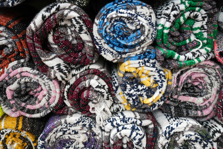 Colorful Mexican southwestern style blankets rolled up on display