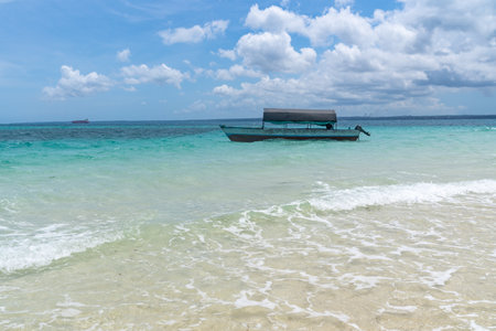 Boat anchored on Prison Island (Changuu Island) just offshore in Zanzibar, Tanzania, waiting for touristsの写真素材