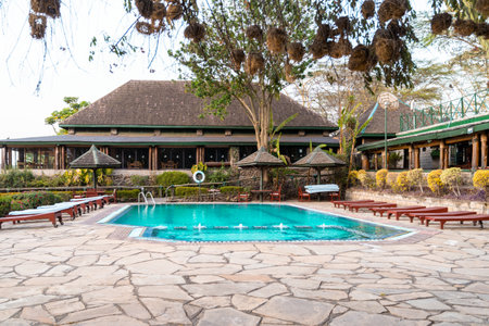Kenya, Africa - March 7, 2023: Pool area and outdoor patio on the grounds of Lake Nakuru Lodge, a safari hotel near the national parkのeditorial素材