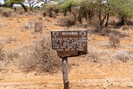 Electric fence with warning sign, risk of wild animals. Taken in Kenya, Africaのeditorial素材