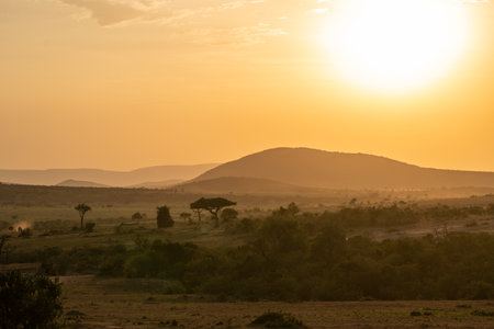 Iconic dusk orange sunset scene in the Masaai Mara reserve in Kenya Africaの写真素材