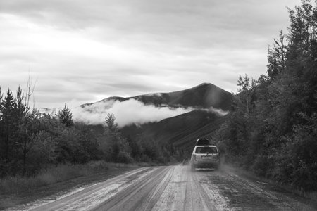Polebridge, Montana - July 3, 2022: Dusty, muddy wet dirt road leading to Polebridge Montana from Glacier National Park on a rainy dayのeditorial素材