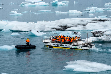 Jokulsarlon, Iceland - July 7, 2023: Tourist boats explore Jokulsarlon glacial lagoon in Iceland, sailing by large chunks of ice. Cold Northern Europe landscapeのeditorial素材