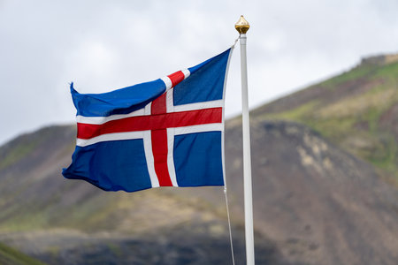 Iceland flag blowing in the wind on an overcast dayの写真素材