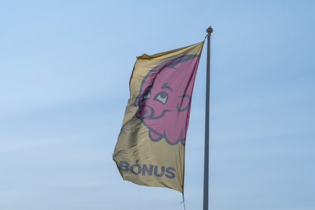 Reykjavik, Iceland - July 11, 2023: Bonus grocery store pig logo flag flies in the wind, advertising the Icelandic chain supermarketのeditorial素材