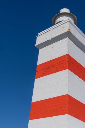Gardur Old Lighthouse in Iceland, white and red striped light house on a sunny dayの写真素材