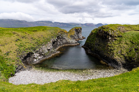 Pumpa viewpoint in Arnarstapi on the Snaefellsnes Peninsula in Iceland. A geological feature of a...