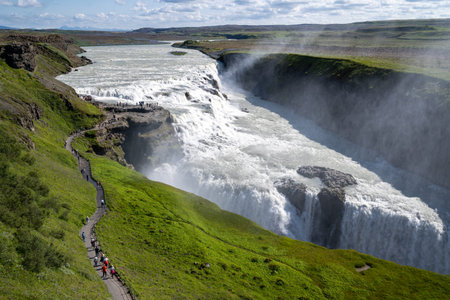 Gullfoss Waterfall - with paths leading to various overlooks, in Iceland during summer. Busy crowds of touristsの写真素材