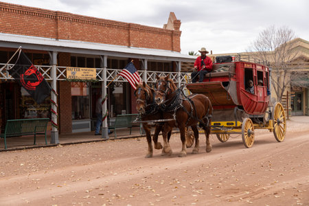Tombstone, Arizona - December 20, 2023: Horse drawn carriage with tourists travels down historic Allen Streetのeditorial素材